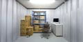 100 sq ft business storage unit neatly organised with office equipment, boxes, and shelving, offering an efficient space for small businesses to store inventory and essential supplies.