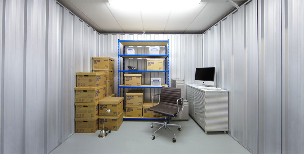 100 sq ft business storage unit neatly organised with office equipment, boxes, and shelving, offering an efficient space for small businesses to store inventory and essential supplies.
