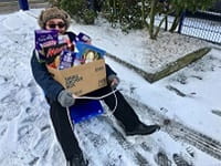 Man with easter eggs in box on sledge