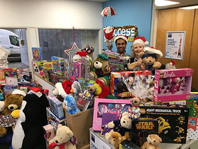 Two store team members behind hundreds of toys donated to Christmas charities