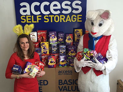 Person wearing a Easter bunny costume and another Access Storage customer presenting the Easter campaign collections