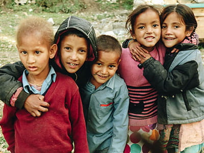 group of children standing on grass field during daytime