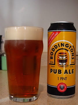 Boddingtons beer in glass and tin