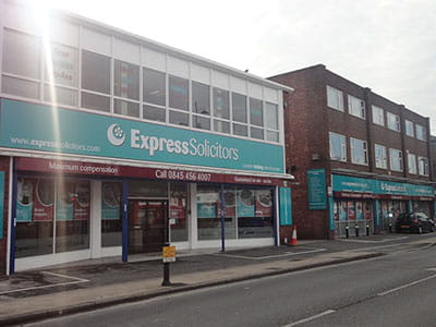 front of 1 storey building with wide signage above entrance