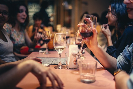 People around table enjoying a drink