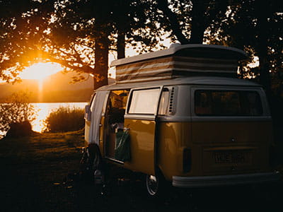 brown van under the tree during sunset