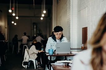 Student on laptop in cafe