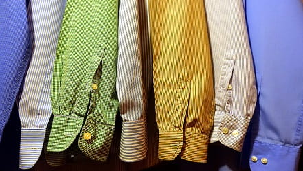 colourful shirts hanging in wardrobe