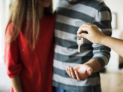 Handing over house keys to couple