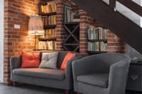 sofa's in alcove under stairs
