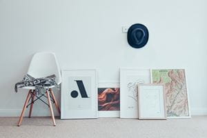 group of paintings leaning against wall