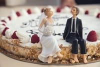 wedding bride & groom figures sitting on cake