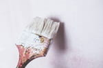 painting a wall with paintbrush