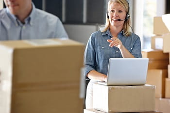 Woman with laptop talking on headset