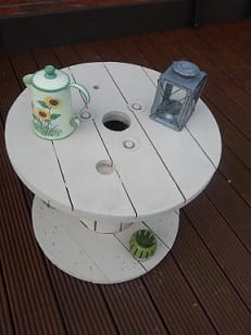 wooden garden table with coffee pot and oil lamp