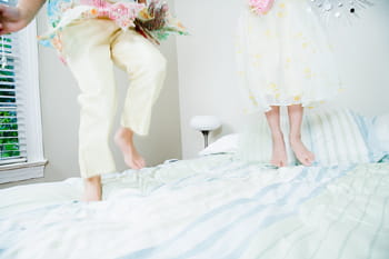 children playing on a bed