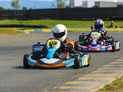 two go kart drivers on race track