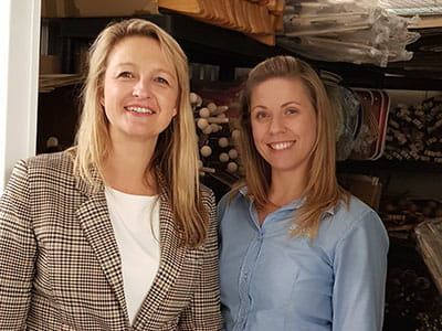 Owner of Green Owl Toys Izabela Hailey in her storage unit with an Access Self Storage team member Dee from Orpington Access Self Storage