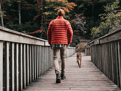 An image of a man walking his dog to accompany our safety tips on dog walking in the dark