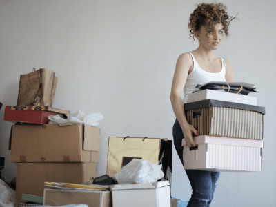 An image of a woman decluttering their home for our New Year decluttering guide