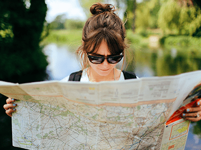 An image of someone looking at a map for our blog on hiking essentials for beginners