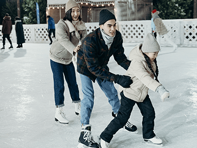An image of a family ice skating for our page on Christmas things to do Manchester