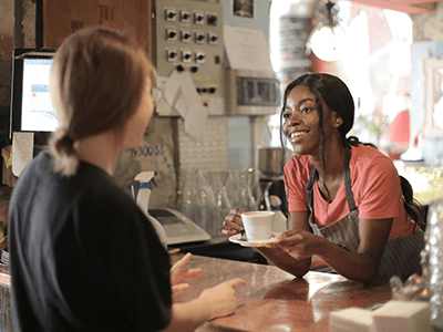 An image of a customer being served for our page on Orpington cafés