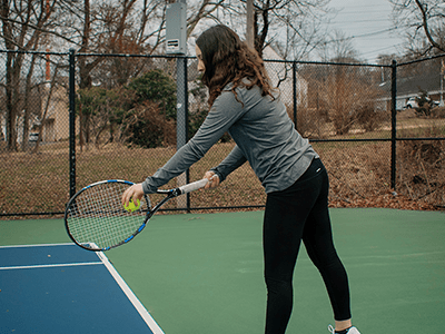 An image of a woman playing tennis for our page on Wimbledon tennis courts
