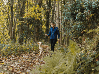 An image of a woman walking her dog for our page on the best walks in Bristol