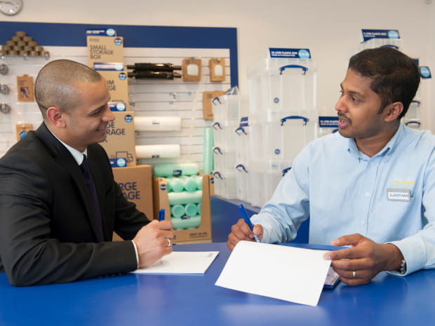 Business person signing Access Self Storage contract